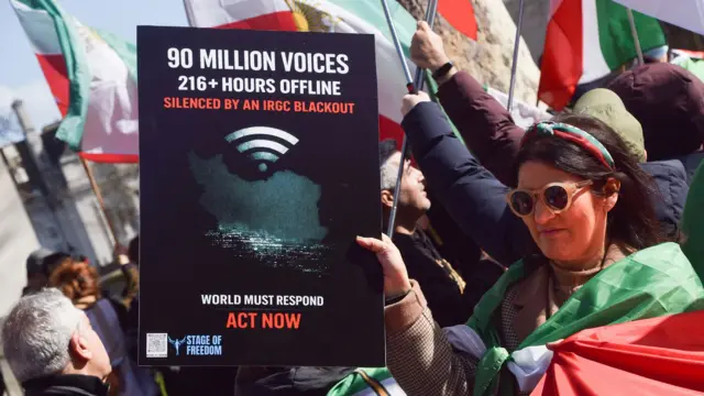 Una mujer sostiene una pancarta contra el bloqueo digital impuesto por las autoridades iraníes.